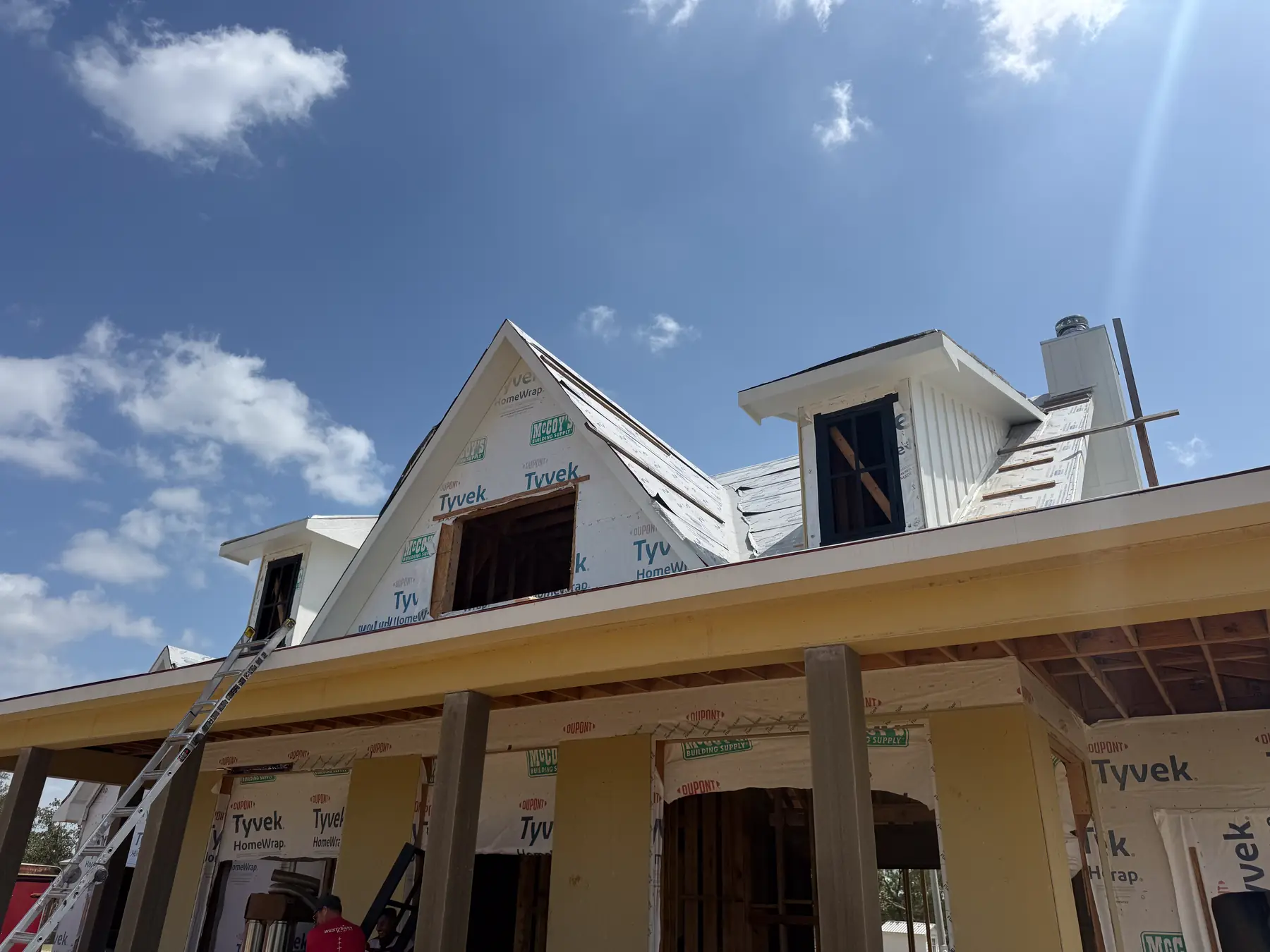 New home under construction with black windows being installed