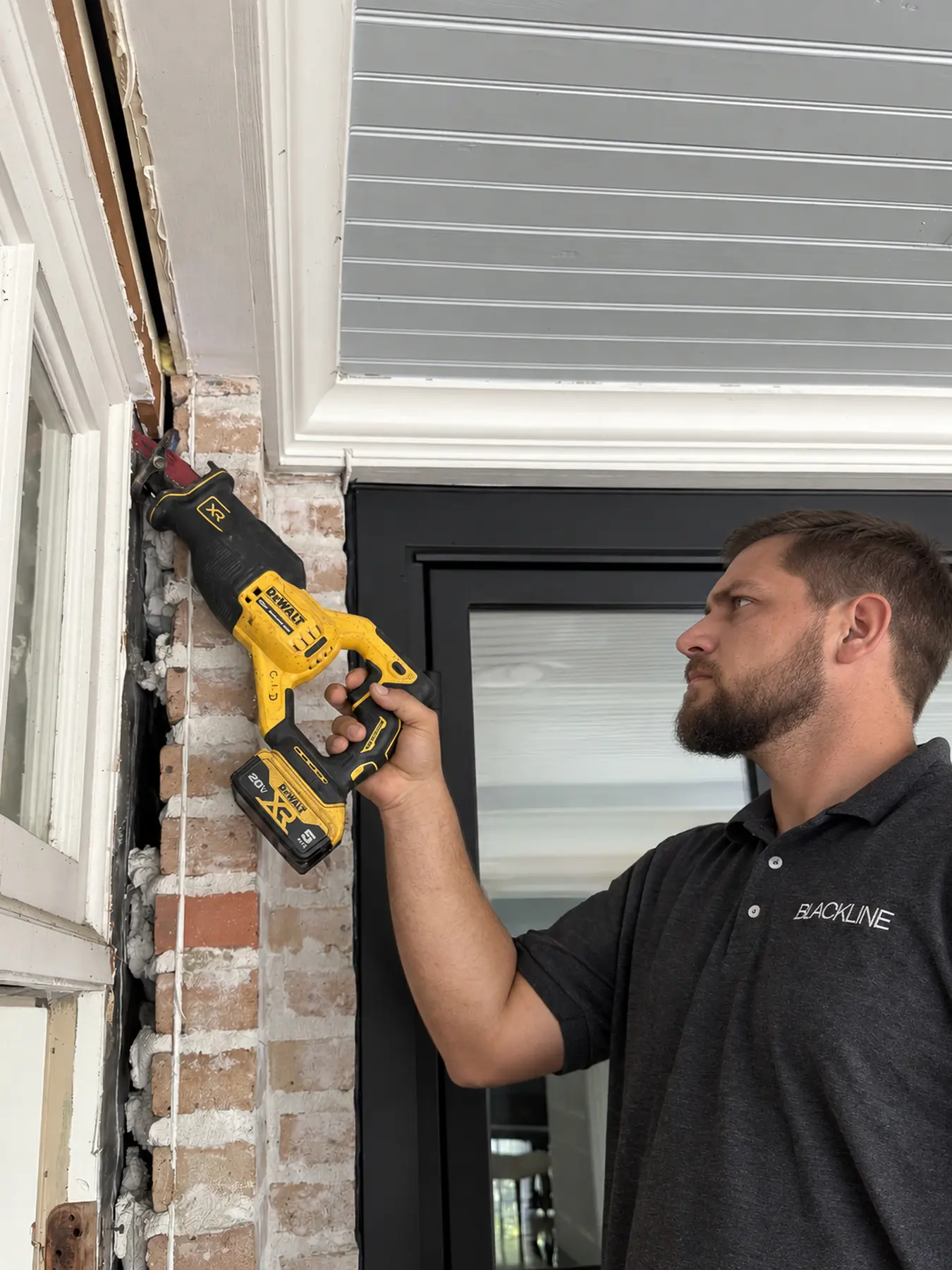 Blackline installer setting a custom iron door in a Houston home