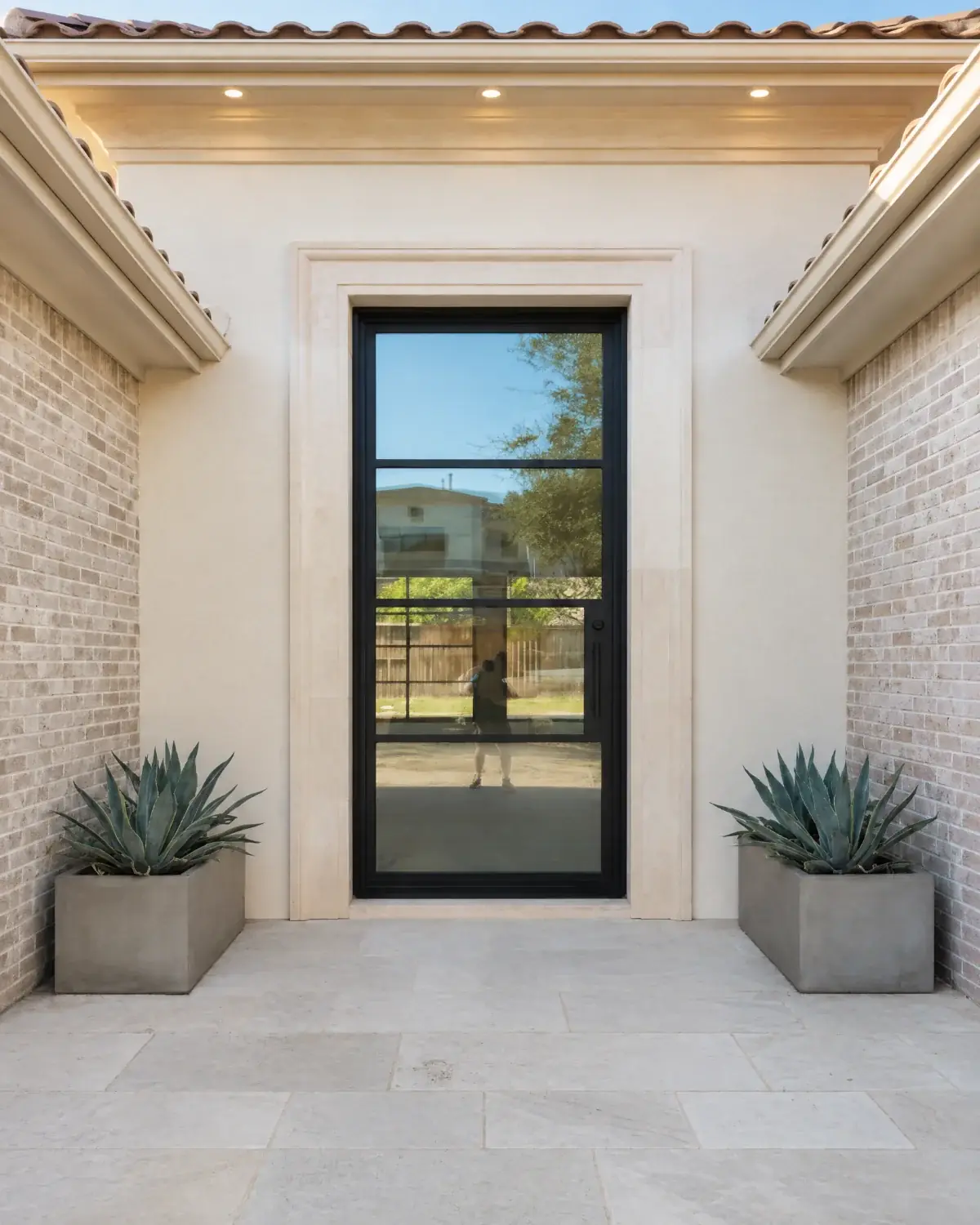 Black iron entry door on a limestone home